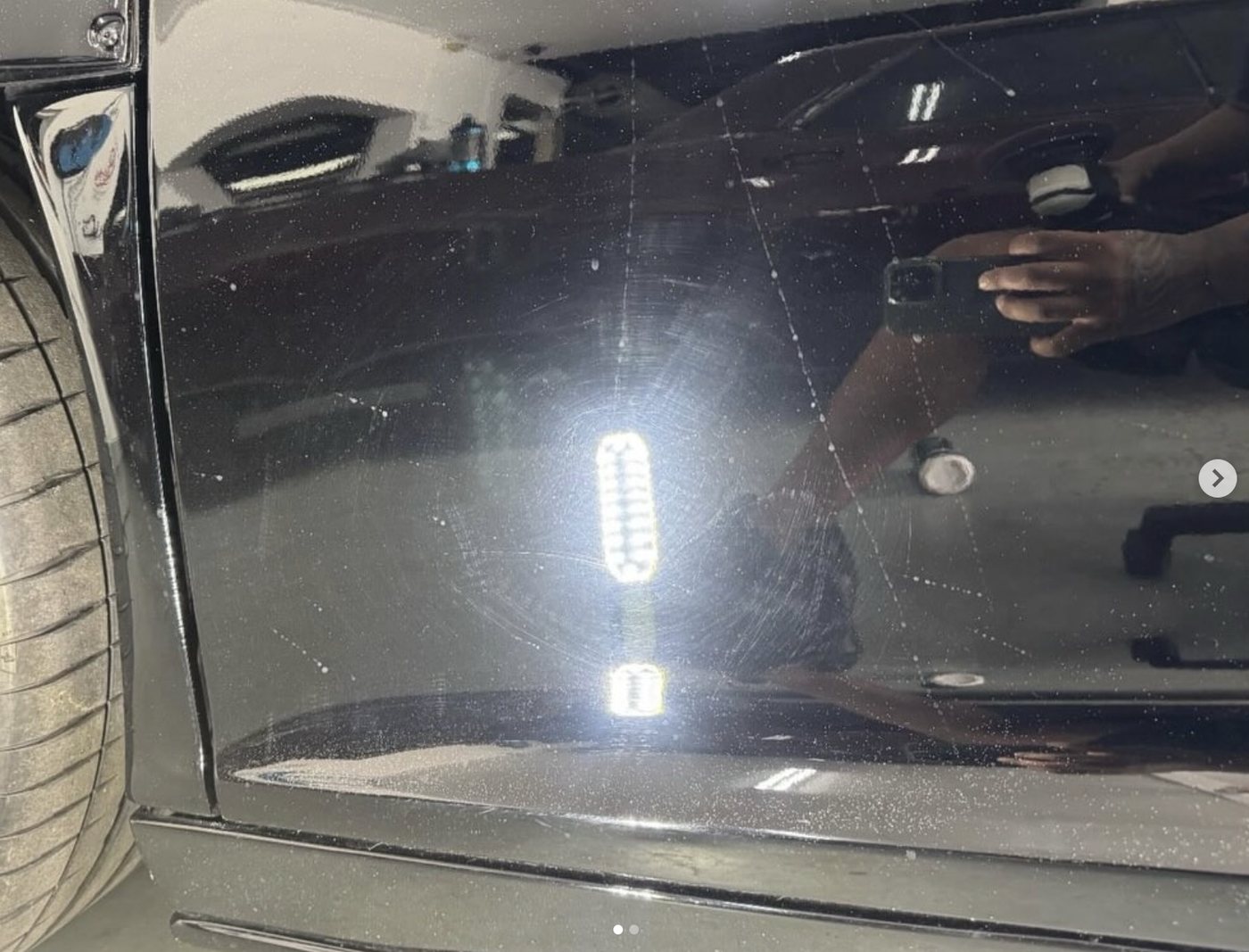 Dark paintwork before correction — swirls and scratches under light